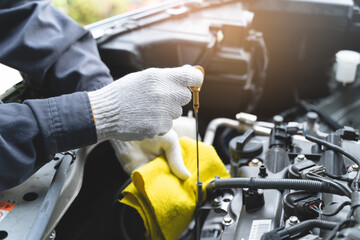 car service shop concept. Automobile repairman work checking change engine oil