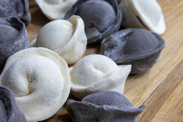 Black and White Dumplings on Kitchen Board, Space for Text. Frozen Dumplings