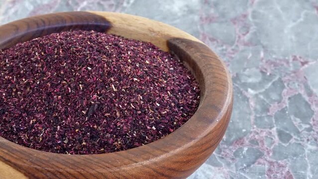 dry roselle leaves in brown wooden plate on blue marble ,pan, close, HD, 24fps