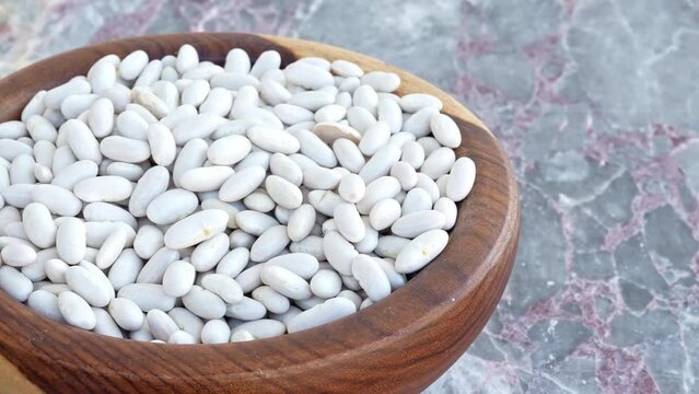 lima beans in brown wooden plate on blue marble ,pan, close, HD, 24fps
