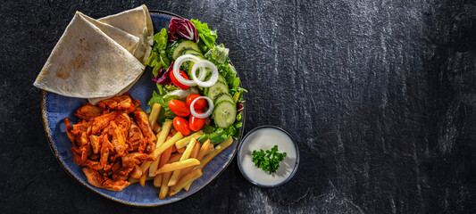 Kebab served with french fries and vegetables