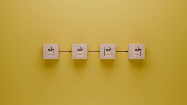 Sequential workflow with wooden blocks on yellow background, document transfer process,  organization and file management concept