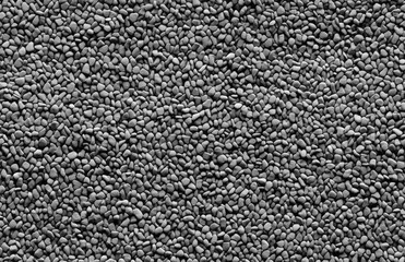 Seamless Monochrome Pebbles or Coarse Sand. A seamless pattern of small stones in varying shades of gray creates a uniform yet intricate surface detail ideal for backgrounds and textural overlays