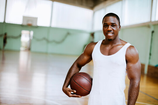Portrait of a young male basketball player in an indoor basketball gym
