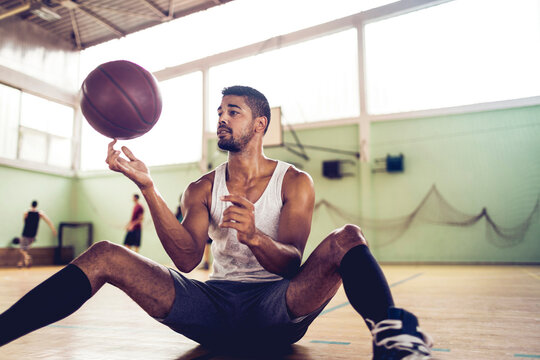 Basketball Player Practicing Ball Handling Skills on Indoor Court
