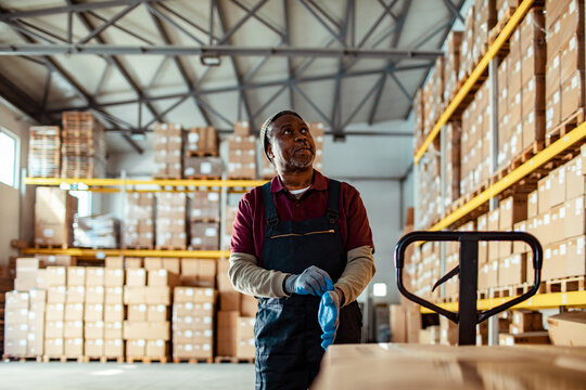 Warehouse Worker Organizing Packages for Shipment