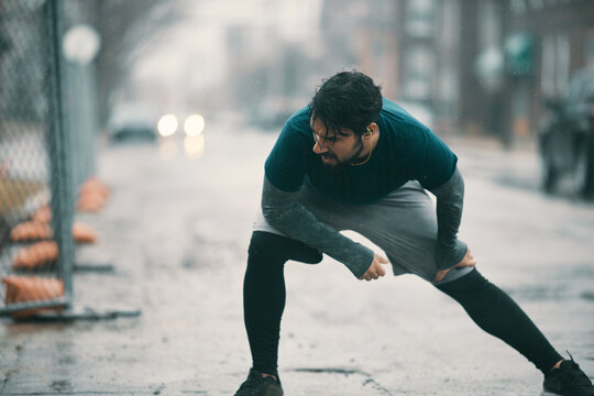 Man resting during outdoor workout in rain