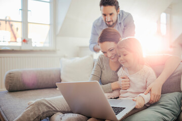 Young family having fun with laptop