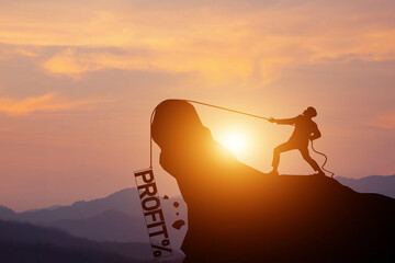 Silhouette of businessman pulling a profit rope with percentage in frame on a mountain with sunset background. concept of Business competition, financial crisis, loss, and investment risks