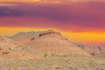 Let the fiery hues of the setting sun take you on an enchanting journey through the enchanting Red Mountains of Boguty. Immerse yourself in the serenity of this desert oasis and let your heart soar