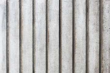 Corrugated metal sheet background. Grunge old grainy metal texture. Silver color industrial pattern. Garage construction gray striped wall. Dirty weathered scratched stripes.