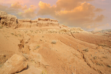 Witness nature's fiery masterpiece as the sun bids farewell behind the Red Boguty Mountains. Desert...
