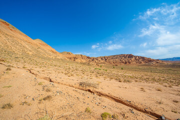 Enjoy the beauty of a desert sunset in the Red Boguta Mountains. Be mesmerized by the golden glow of the sun illuminating the jagged peaks. Witness a breathtaking and awe-inspiring spectacle