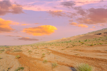 Enjoy a spectacular desert sunset in the Boguty Mountains. Witness the art of nature as vibrant...
