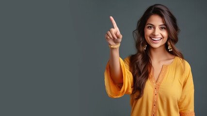 Happy indian woman pointing her finger at copy space for promotion