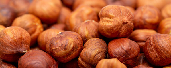 Heap of hazelnuts close-up. Peeled nuts. Hazelnut isolated on white background.