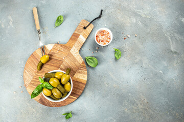 olives with pickled cucumbers in a bowl on a light background Long banner format. top view. place for text - Powered by Adobe