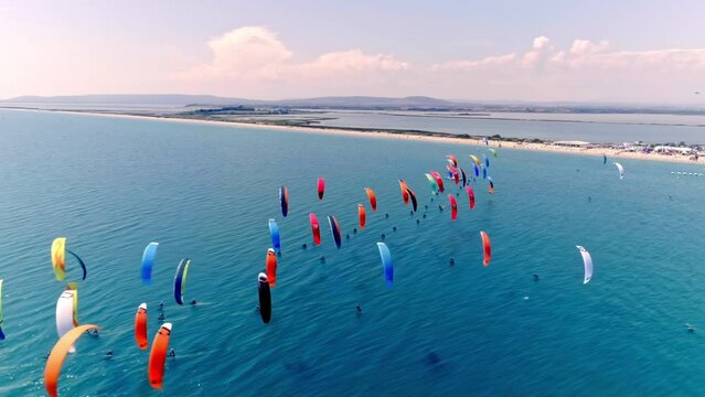 Kite surfers glide on the French coastal waters.