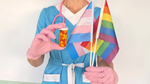 Doctor shows LGBT pride flag and medical pills hormone therapy. Medical support for the LGBT community and symbol of tolerance