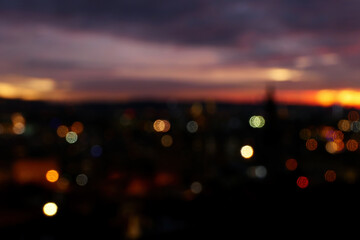 defocused blurry sunset in the city with bokeh lights 