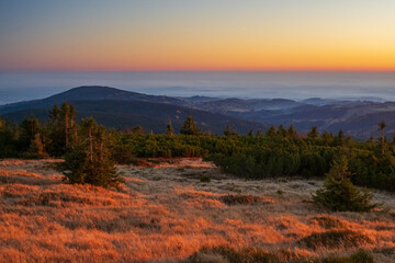 View from the mountains to the valley at sunset during the inversion