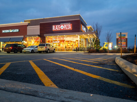 New Hartford, NY - Nov 23, 2022: Landscape night view of Blaze Pizza Restaurant. Blaze Pizza is a fast-casual pizza chain known for its build-your-own pizza concept in 2011 by Rick and Elise Wetzel.