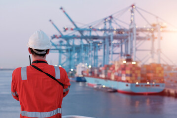 Offshore Project Manager Technician. Seafarer. Seaman. Navigator. A Man In A Boiler Suit Is Standing In Front Of The European Port. Seafarer In Front Of The Container Terminal.