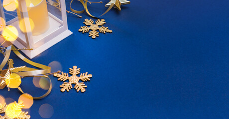 Christmas composition with lantern and christmas decorations, garland on a blue background. Winter...
