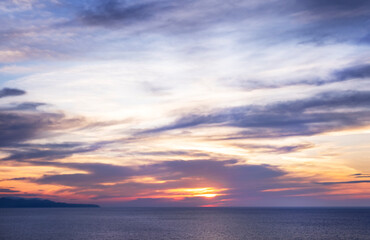 Fototapeta na wymiar Sunset over sea in Corfu island in Greece. Summer time and mood. Beautiful vibrant evening. Copy space.