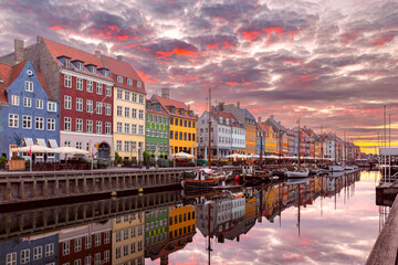 Copenhagen. Nyhavn canal colorful traditional houses and city embankment at sunrise.