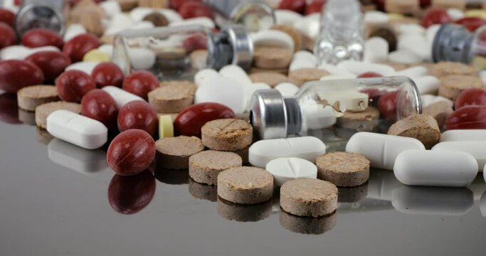 Pharmacy background on a metal surface. Tablets, pills, glass flacons and ampoule. Medicine and healthy. Close up of capsules.