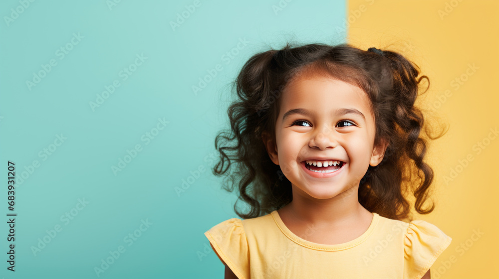 Wall mural Cute little girl portrait on studio background