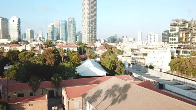A drone flies towards the city of Tel Aviv with a view of the skyscrapers