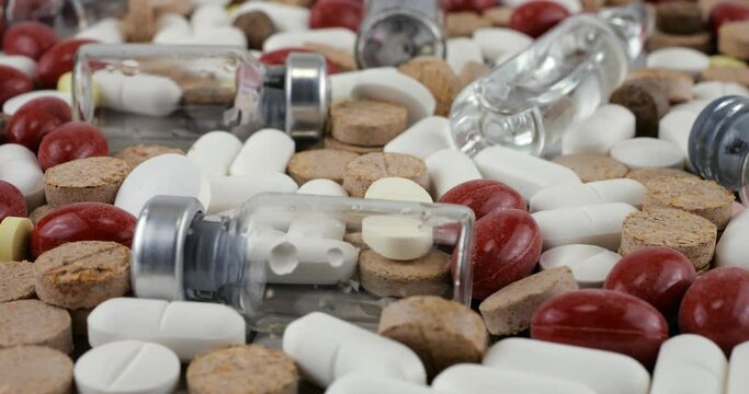 Pharmacy background on a metal surface. Tablets, pills, glass flacons and ampoule. Medicine and healthy. Close up of capsules.