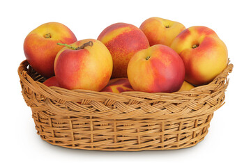 Ripe nectarine fruit in a wicker basket isolated on white background with full depth of field