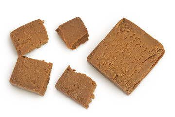 Brown cheese. Norwegian brunost isolated on white background. Top view. Flat lay