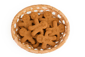 Gingerbread man in a wicker basket isolated on white background. Top view. Flat lay.