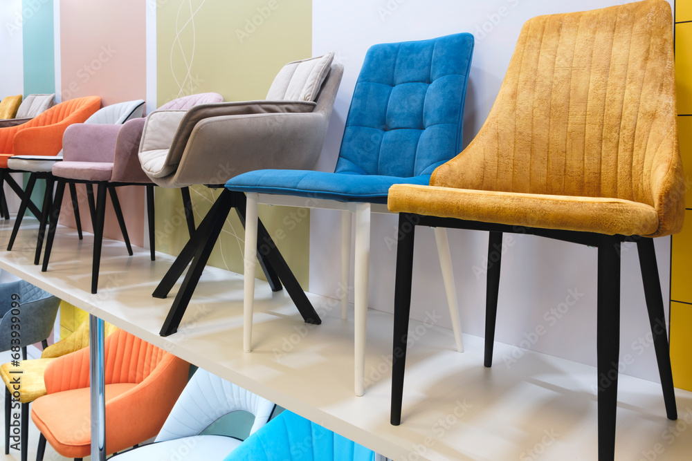 Poster many different chairs and armchairs on display in a furniture store