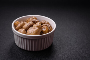 Delicious juicy whole champignons baked on the grill with salt and spices