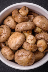 Delicious juicy whole champignons baked on the grill with salt and spices
