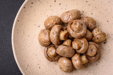 Delicious juicy whole champignons baked on the grill with salt and spices