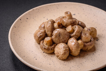Delicious juicy whole champignons baked on the grill with salt and spices