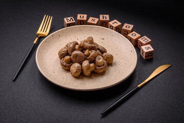 Delicious juicy whole champignons baked on the grill with salt and spices