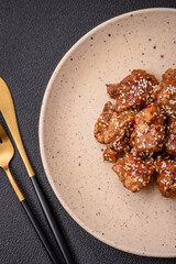 Delicious Asian dish with pieces of chicken in teriyaki sauce with salt and spices