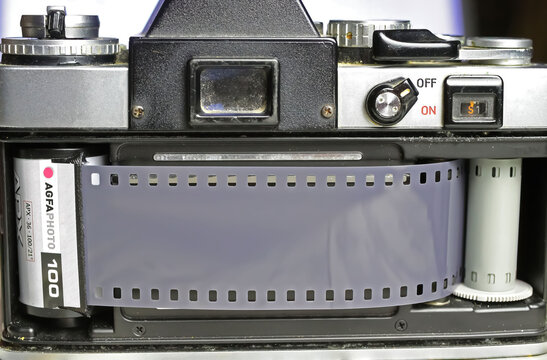 Viersen, Germany - June 9. 2023: Closeup of retro Minolta XE 5 analog camera film compartment with reel and black and white Iso 100 Agfa roll