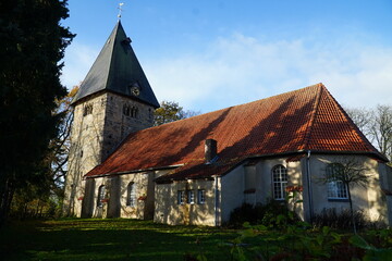 Fototapeta premium The Evangelical Lutheran village church of St. Cyriakus, Simon and Judas in the village Basse, Hanover region, Lower Saxony, Germany. It was built around the year 1100.