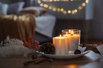 autumn and winter home decor with burning candles