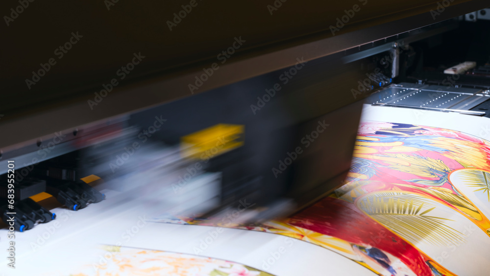 Poster a moving working industrial wide format printer prints a color picture on paper.
