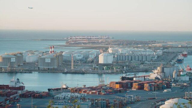 Industrial port of Barcelona with ships, cargo containers and loading cranes.