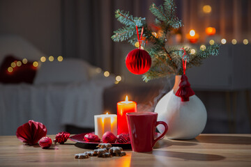 hot drink in red cup with christmas decorations at home